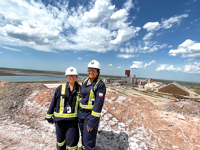 Sunnette Kamffer and Sierra DSouza Butts at the top of the salt pile at the Rocanville site.<br />
